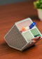 Stylish angled desk organizer with four compartments, holding colorful pens and markers, ideal for office or home workspace organization.