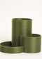 Set of green ribbed planters on a white background