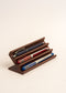 Wooden pen holder with three pens on a  white background