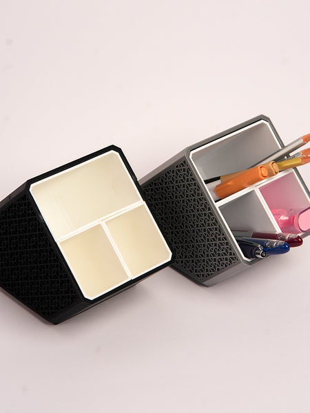 Stylish angled desk organizer with four compartments, holding colorful pens and markers, ideal for office or home workspace organization.