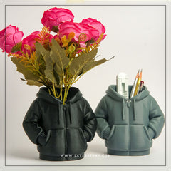 Black & grey colour hoodie-shaped pen holder with stationery items on a light pink background
