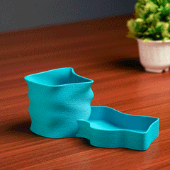 Teal pen holder with stationery items on a light background
